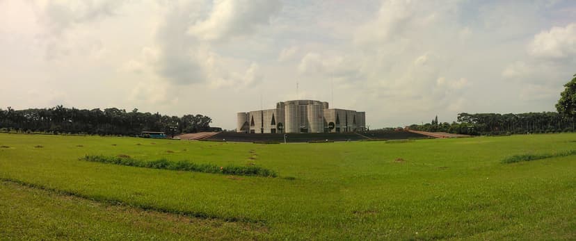 Panoramic view of the National Assembly building of Bangladesh in Dhaka, a modernist concrete structure surrounded by an artificial lake