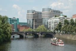 The former German Federal Ministry of the Interior building in Berlin, viewed from across the River Spree, with its distinctive twin towers rising above the waterfront
