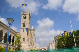 Gothic coral-limestone Parliament Buildings with clock tower in Bridgetown, Barbados