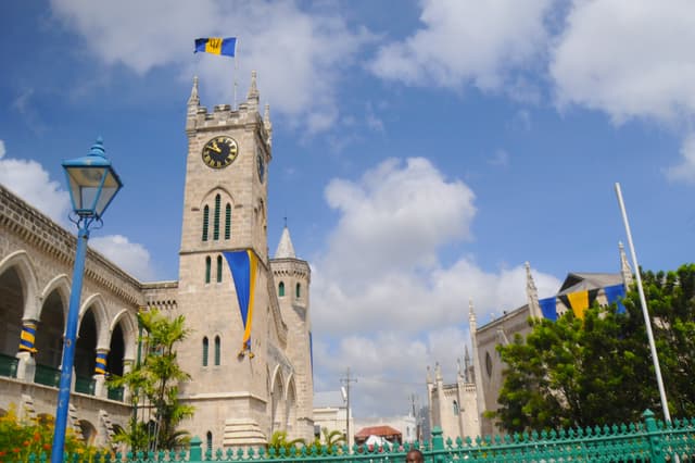 Gothic coral-limestone Parliament Buildings with clock tower in Bridgetown, Barbados