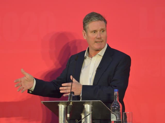 A politician speaking at a podium during a Labour Party event in the United Kingdom
