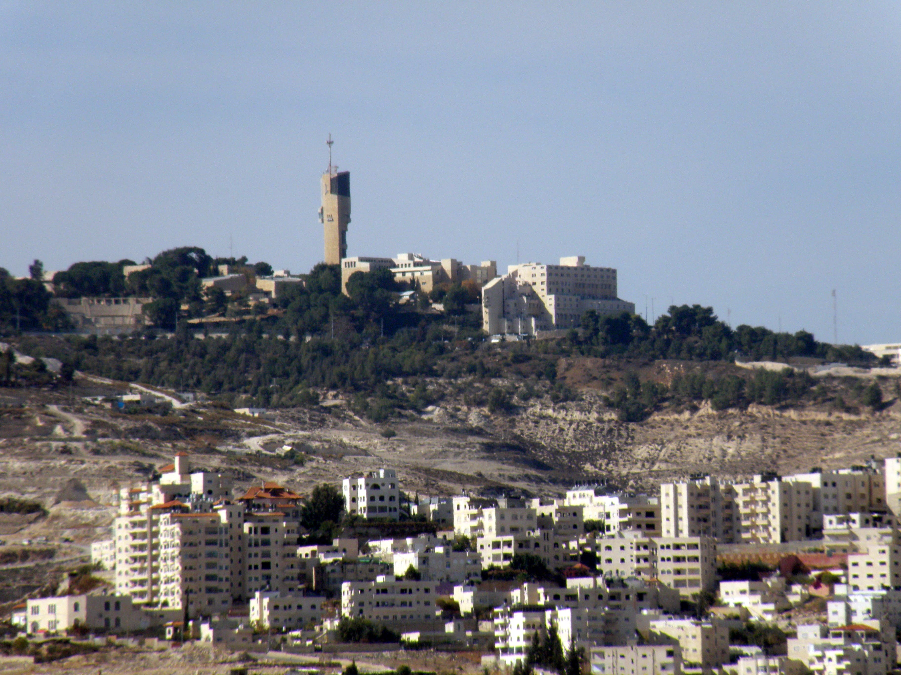 Aerial view of a large Israeli settlement built on hillside terrain in the occupied West Bank