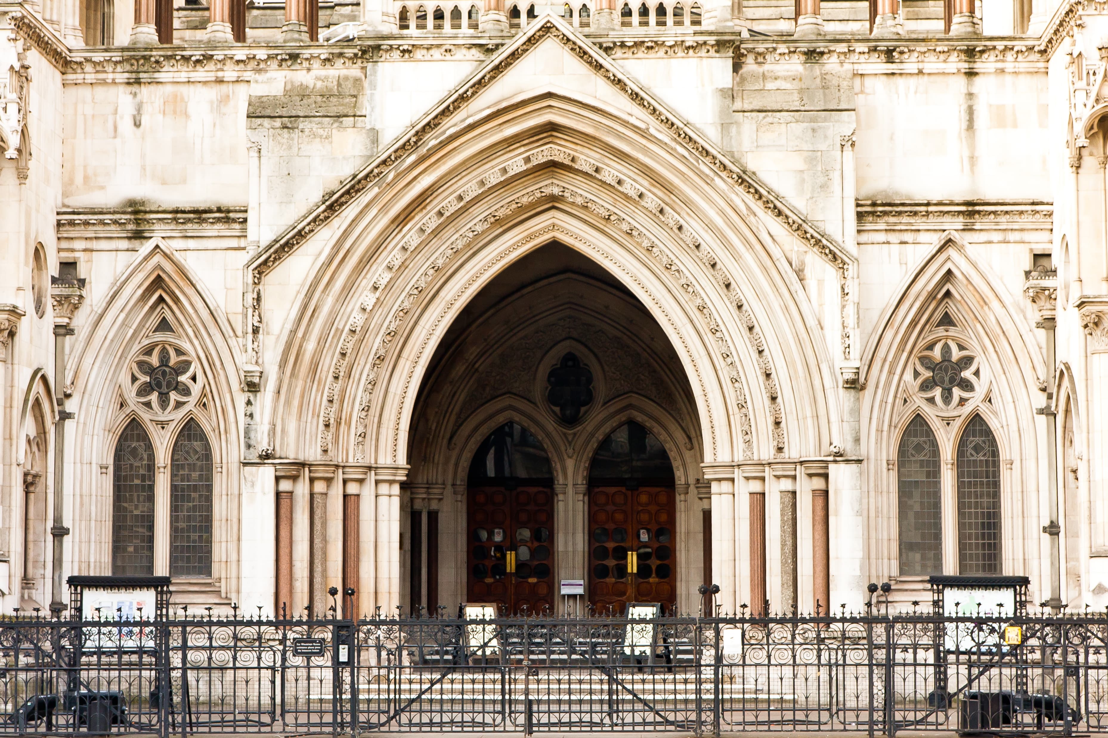The main entrance of the Royal Courts of Justice in London, a Victorian Gothic stone building with an ornate arched doorway