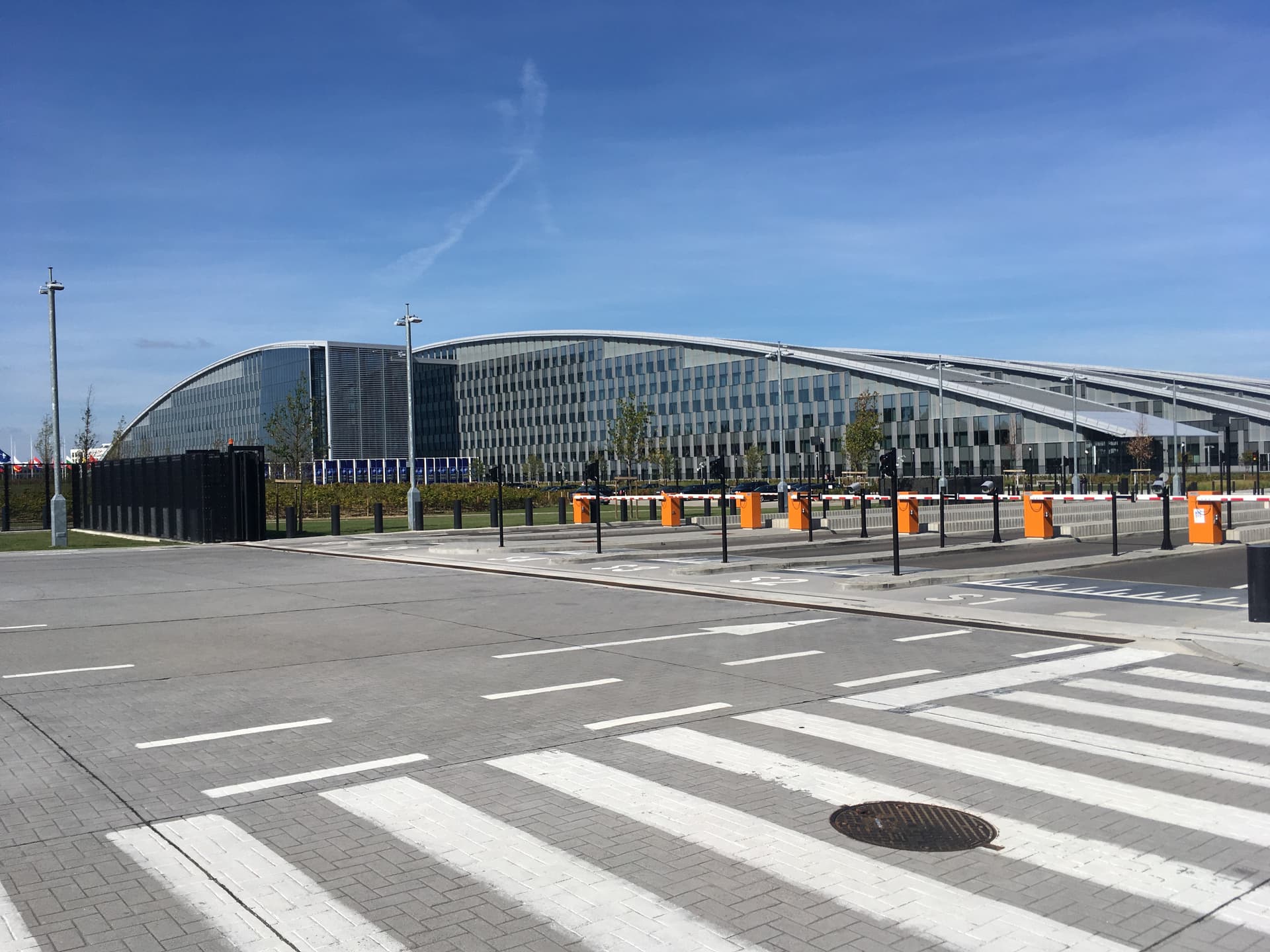 The new NATO headquarters building in Brussels, a modern glass and steel structure seen from an exterior viewpoint